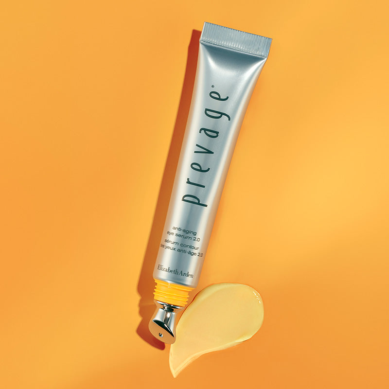Prevage skincare tube with applicator on an orange background