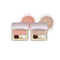 Two open makeup compacts with metallic rose-gold lids, shown side by side on a white background with loose powder swatches behind them. The left compact contains a soft pink blush and the right contains a light champagne-beige highlighter, both with small applicators.