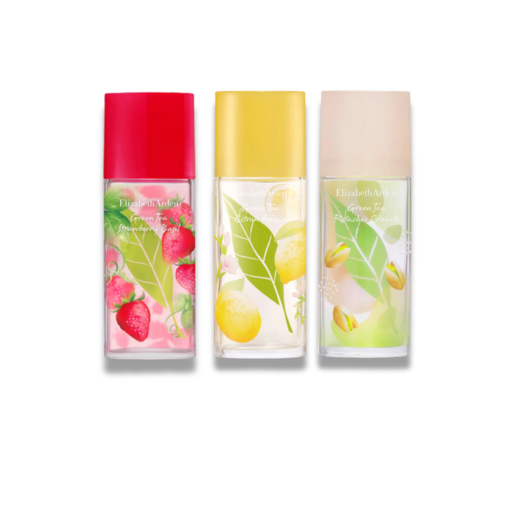 Three clear rectangular perfume bottles with printed fruit and leaf graphics, shown side by side on a white background. The left bottle has a bright pink cap and strawberry/rose imagery, the middle has a yellow cap and lemon imagery, and the right has a pale blush cap with citrus and green leaf imagery.