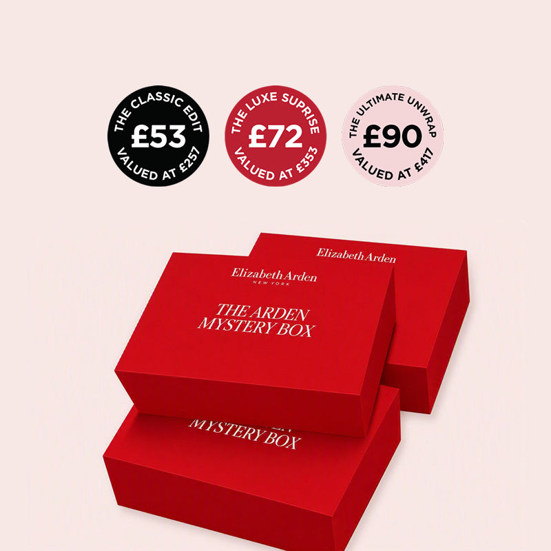 Three red Elizabeth Arden The Arden Mystery Box packaging boxes are shown on a pale pink background, with three circular price badges above them reading The Classic Edit valued at £53, The Luxe Surprise valued at £72, and The Ultimate Unwrap valued at £90.