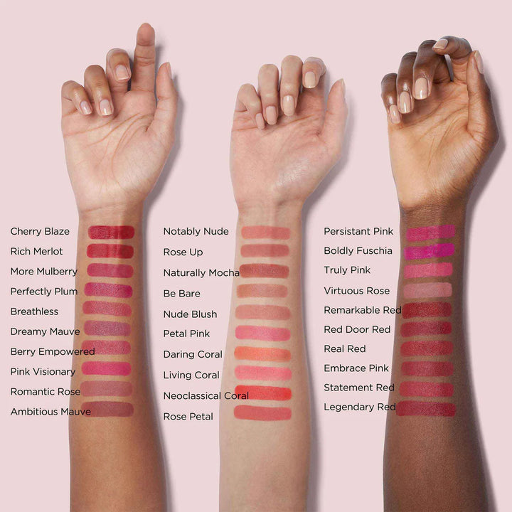 Three hands with various lipstick swatches on a pink background