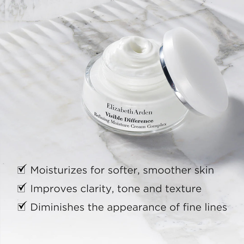 Elizabeth Arden Visible Difference cream jar on a marble surface with product benefits listed.