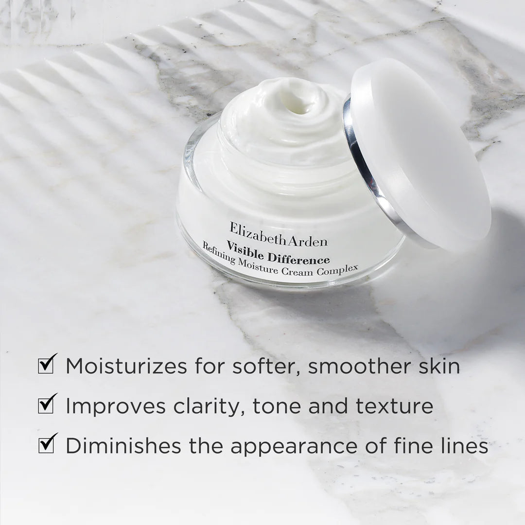 Elizabeth Arden Visible Difference cream jar on a marble surface with product benefits listed.