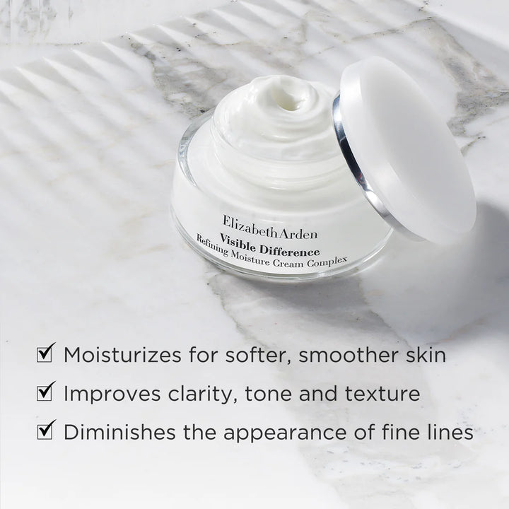 Elizabeth Arden Visible Difference cream jar on a marble surface with product benefits listed.