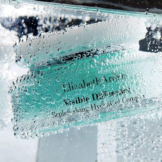 Elizabeth Arden Visible Difference skincare product with water droplets on a blurred background
