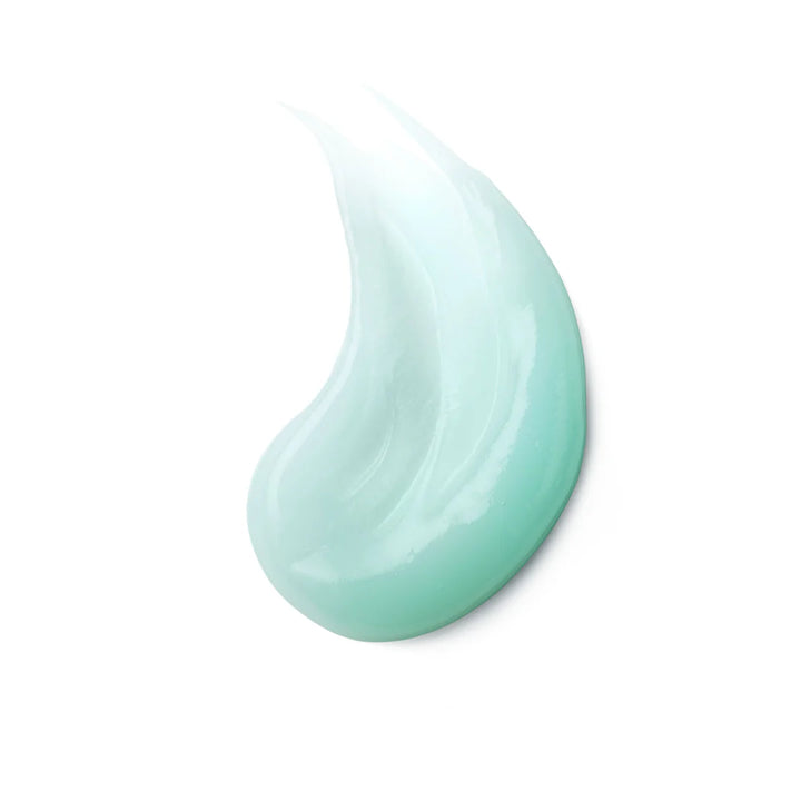 Close-up of a light blue cream droplet on a white background
