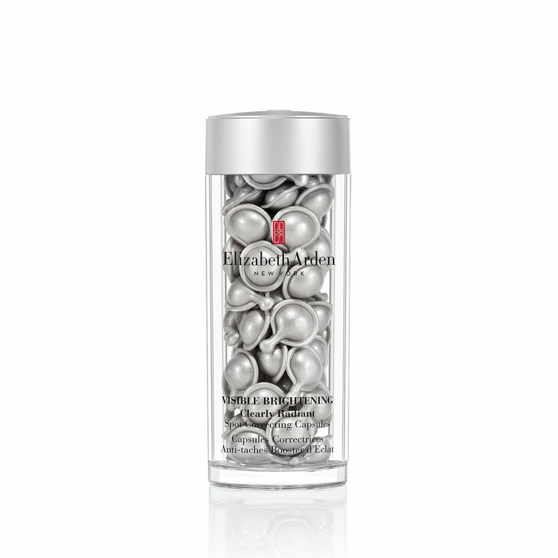 Elizabeth Arden Visibly Brightening Ultra Caps in a clear cylindrical bottle with a metallic silver cap, showing the silver gel capsules inside.