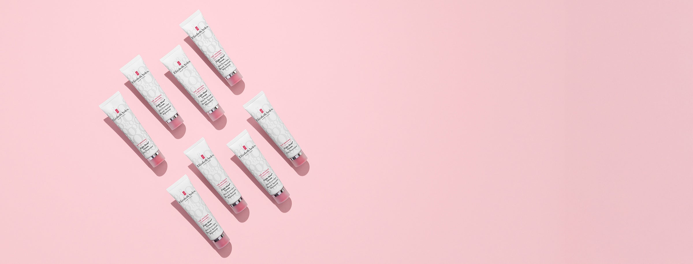 Multiple Eight Hour Skin Protectants arranged in a pattern on a pink background for desktop
