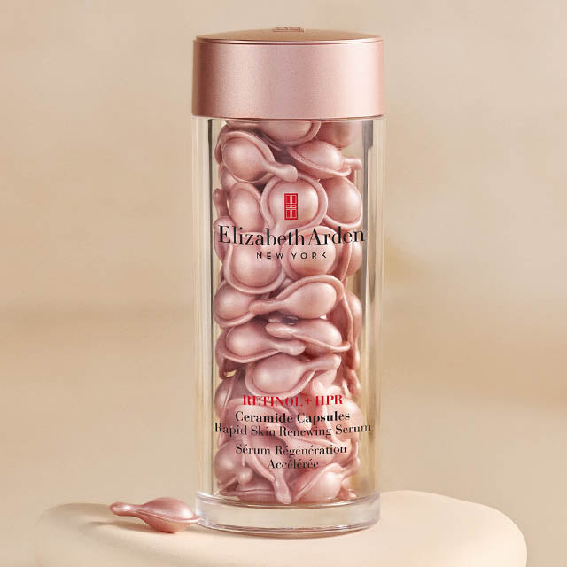 Elizabeth Arden Ceramide Capsules in a clear container with a pink lid on a beige background